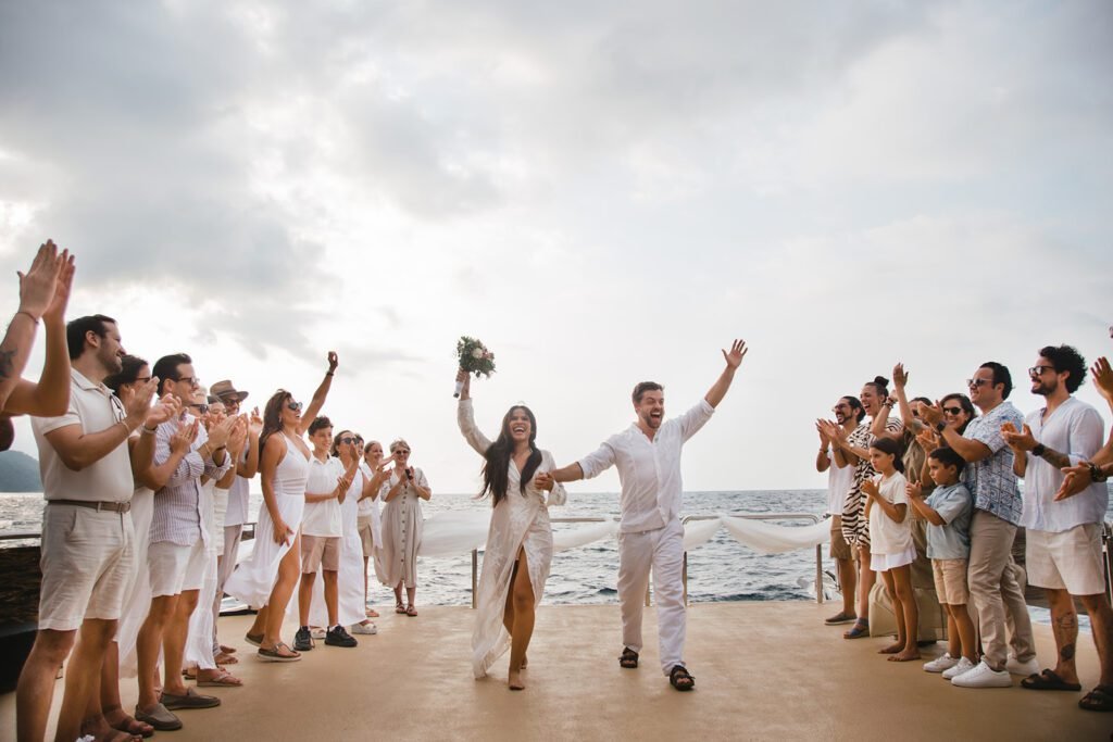 Newlyweds celebrating with guests on the beach